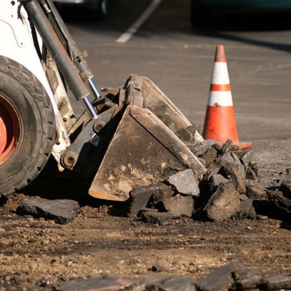 bulldozer picking up broken road